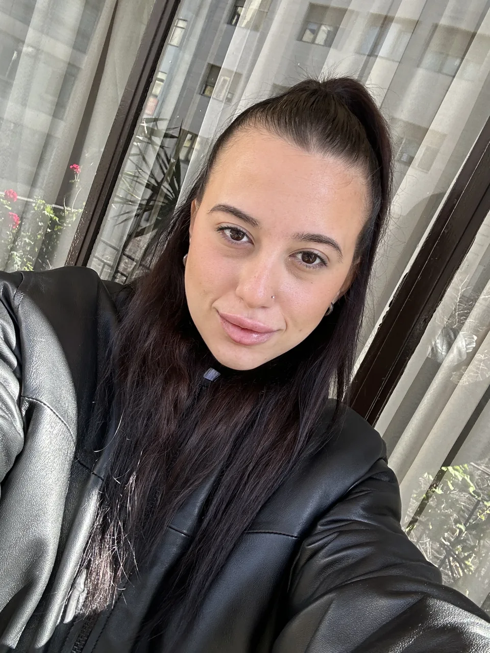 Natalye in a black jacket, photographed in the sunshine